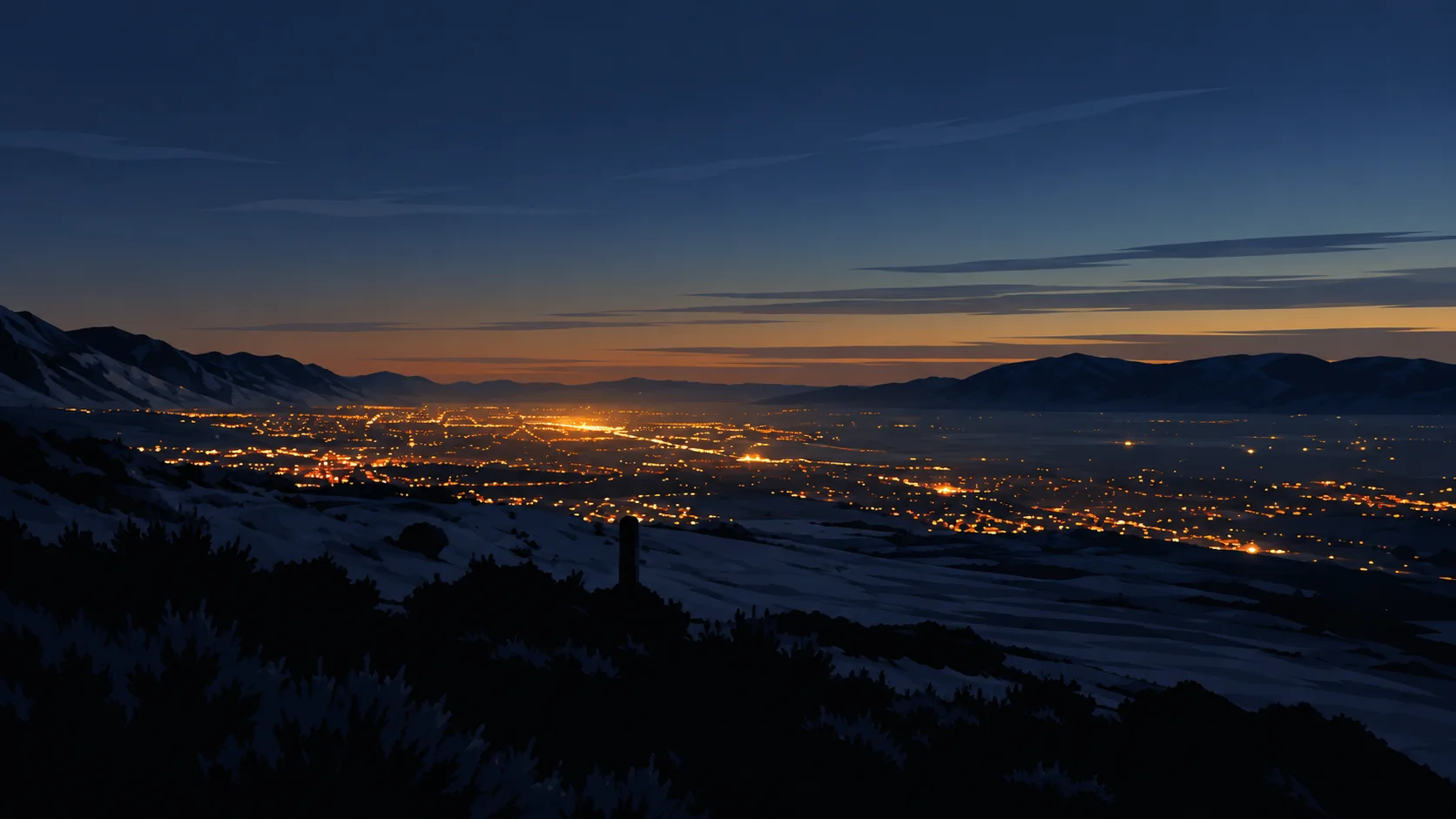 Mountain silhouettes and warm city lights across a northern Utah valley at dusk.